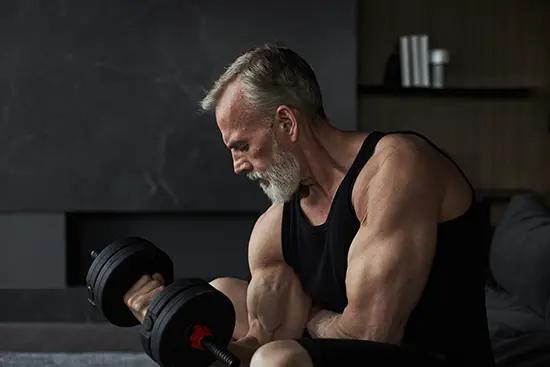 Man over 50 weight training in gym