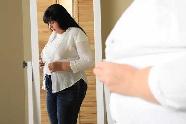 Woman over 50 addressing menopause belly fat through strength training